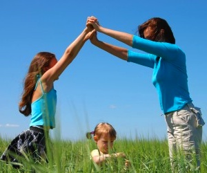 Mom with Girls in a Grassy Field